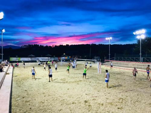 a group of people playing a game of volley ball on a beach at Agriturismo AgrileisureTime in Spoleto
