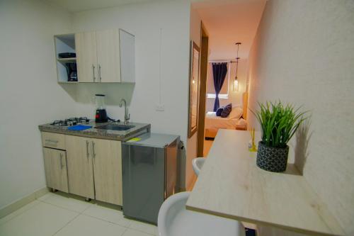 a kitchen with a sink and a counter top at Moderno loft en el centro de Pereira in Pereira