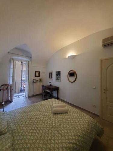 a bedroom with a bed and a desk in a room at Gallina Apartment in Bra