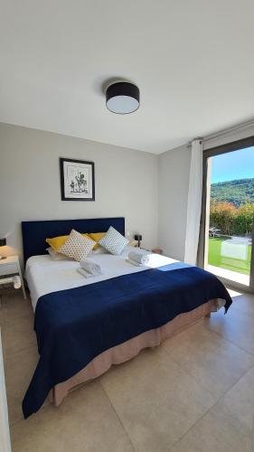 a bedroom with a large bed with a large window at Villa Zola Apartment, the magic of the French Riviera in Le Bar-sur-Loup