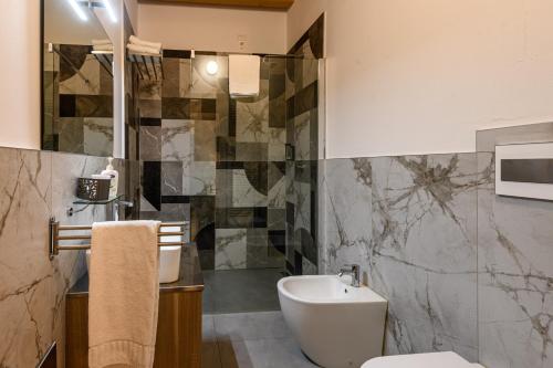 a bathroom with a toilet and a sink at il Glicine B&B RISTORANTE in Cazzago San Martino