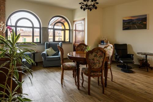 a living room with a table and chairs at il Glicine B&B RISTORANTE in Cazzago San Martino