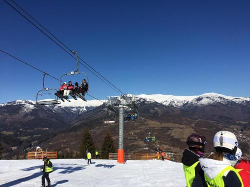 a group of people on a ski lift in the snow at Zaži Apartmány Mýto pod Ďumbierom in Mýto pod Ďumbierom