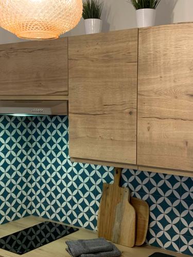 a wooden cabinet in a room with blue and white tiles at Le Cabanon de Livia avec piscine privée in Cucuron