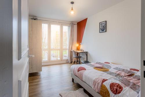 1 dormitorio con cama, ventana y escritorio en Résidence Bonaparte en Laval