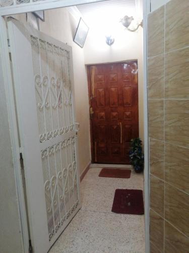 a hallway with a gate and a door at Appartement Fes très propre et calme in Fez