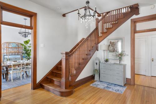 a wooden staircase in a home with a dining room at Dubuque's Front Porch, Historic Charmer, Walk Downtown in Dubuque
