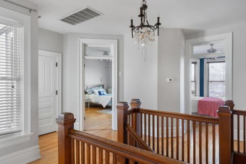 a room with a staircase and a chandelier at Dubuque's Front Porch, Historic Charmer, Walk Downtown in Dubuque