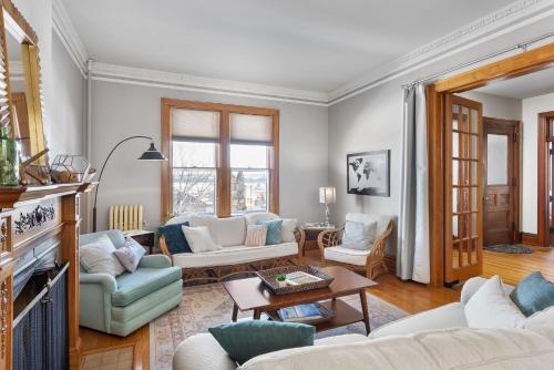 a living room with a couch and a table at Dubuque's Front Porch, Historic Charmer, Walk Downtown in Dubuque