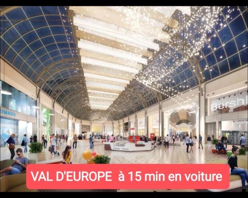 a rendering of a shopping mall with people in it at La Marisa, studio cosy 10min Disney. in Crecy la Chapelle