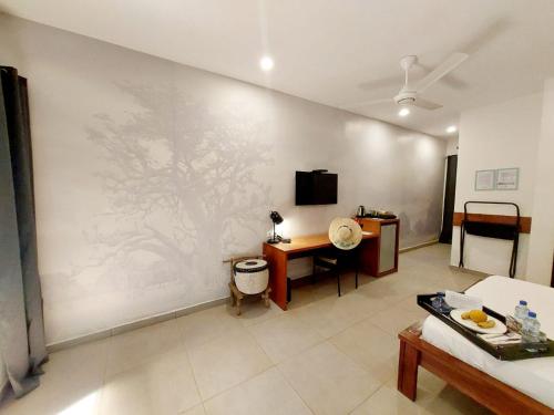 a living room with a painting on the wall at L'Hédone, hôtel de charme in Ouagadougou