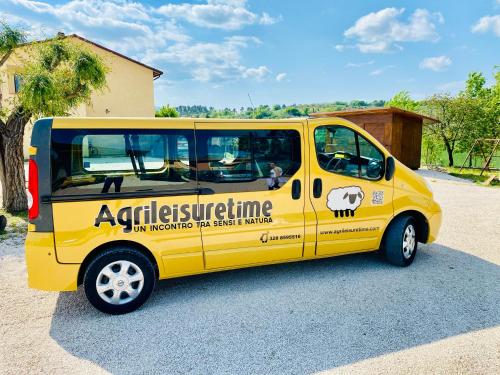 a yellow van parked in a parking lot at Agriturismo AgrileisureTime in Spoleto