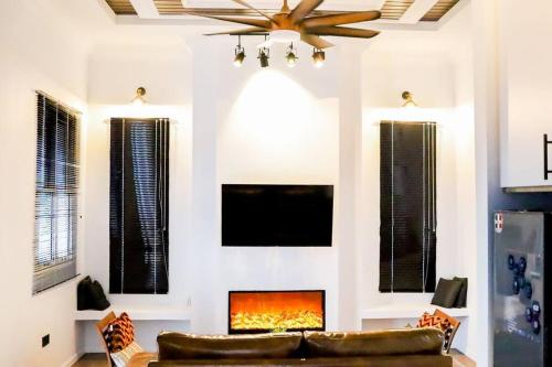 a living room with a couch and a fireplace at Tanjung Jara Cottage - with indoor pool in Dungun