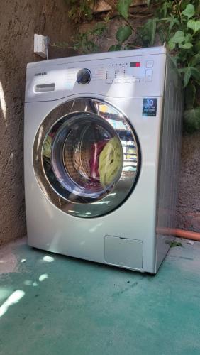 a washing machine is sitting on the ground at Cabañas swissminiatur in Cacheuta