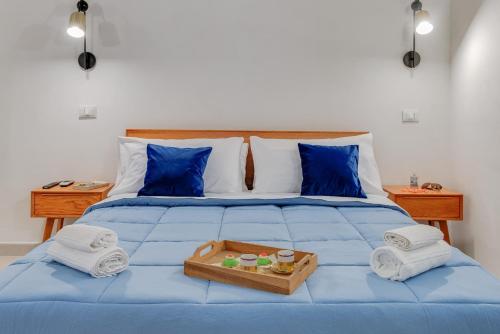 a blue bed with towels and a tray on it at L'Antro di Dedalo in Sciacca