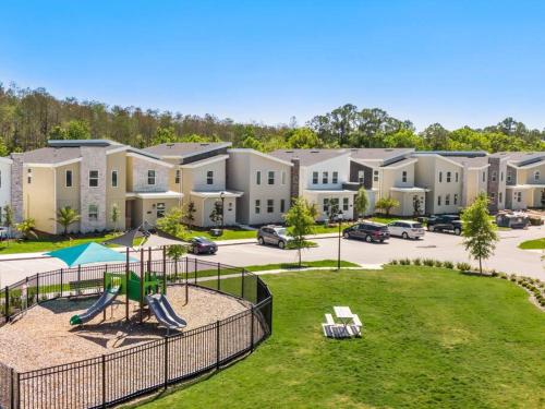 an apartment complex with a playground in a park at Luxury 9BR Villa @ Storey Lake Resort Near Disney in Kissimmee