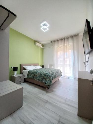 a bedroom with a bed and a large window at L.ADY HOME in Bologna