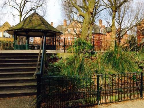 a gazebo in a park next to some stairs at Centrally Located London Apartment in London