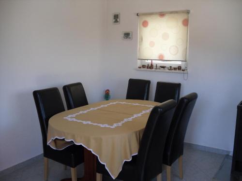 a dining room with a table and chairs at Apartment Marina in Sevid