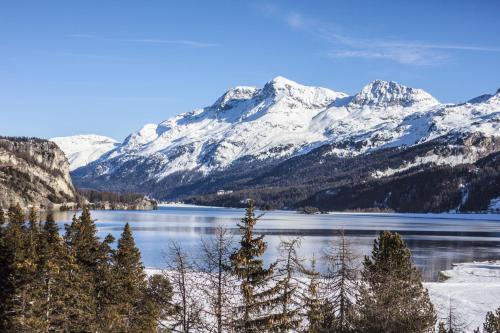 a view of a lake with snow covered mountains at Maloja Palace Residence Engadin-St Moritz CO2-Neutral in Maloja