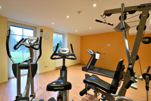 a gym with several exercise bikes in a room at Best Western Plus Parkhotel Maximilian Ottobeuren in Ottobeuren