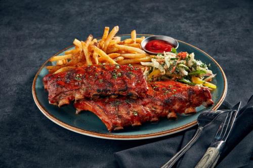 a plate of food with meat and french fries at Niagara Falls Marriott on the Falls in Niagara Falls