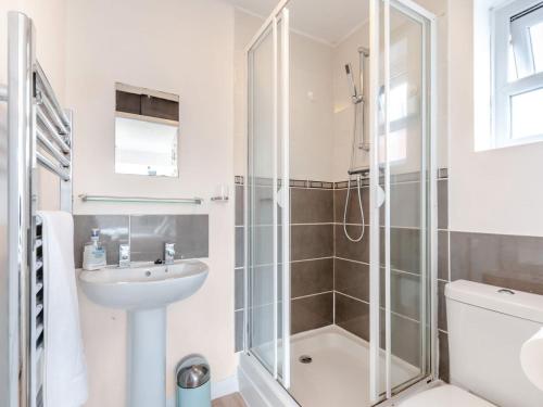 a bathroom with a shower and a sink and a toilet at Turnstone House in Birchington