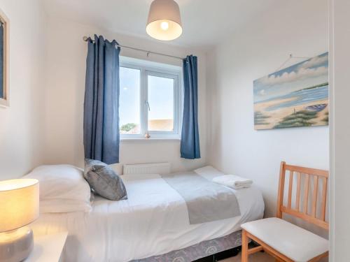 a bedroom with two beds and a window at Turnstone House in Birchington