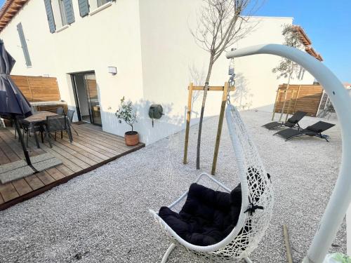 a hammock in the backyard of a house at Villa 8 personnes bord de mer climatisée in Saintes-Maries-de-la-Mer