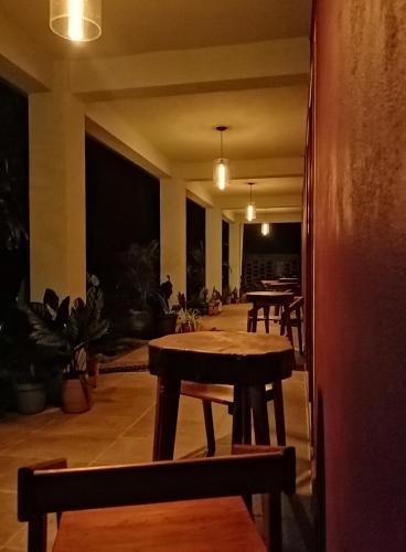 a room with tables and benches and potted plants at La Morada, una ventana al golfo - Hotel boutique in Monte Gordo