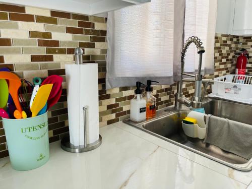 a kitchen counter with a sink with utensils at SALT ST LUCIA in Vieux Fort