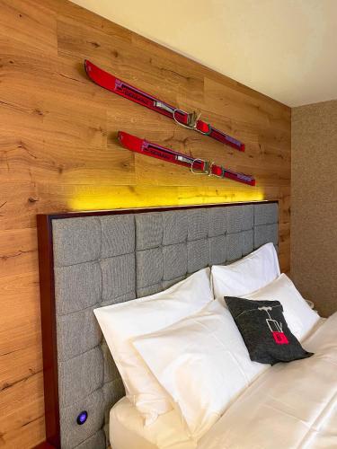 a bed with two baseball bats on a wall at Wunderstay Alpine 203 Chic Studio with Balcony, Mountain and Lake view in Engelberg