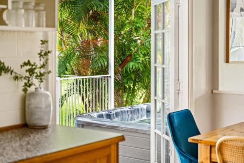 a kitchen with a sliding glass door to a patio at Koala Shores Holiday Park in Lemon Tree Passage