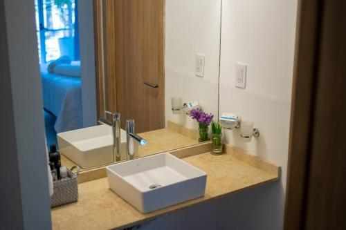 a bathroom with a white sink and a mirror at In Calma Mdz in Mendoza