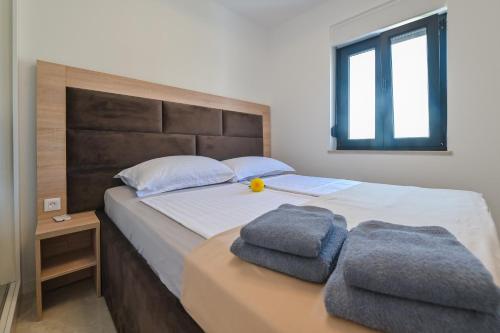 una camera da letto con un letto e due asciugamani di Villa Ami a Kustići
