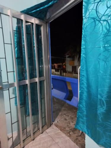 a view from the outside of a balcony at night at Casa de los Cruz in Leticia