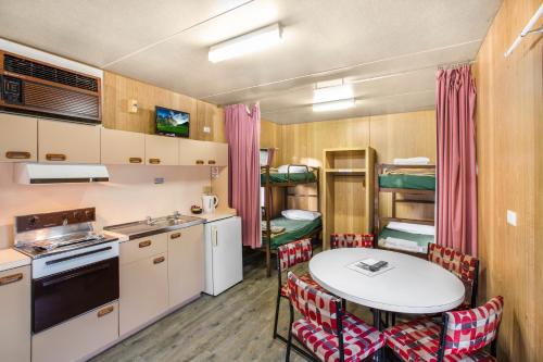 a kitchen and dining room with a table and chairs at Breeze Holiday Parks - Grampians in Halls Gap