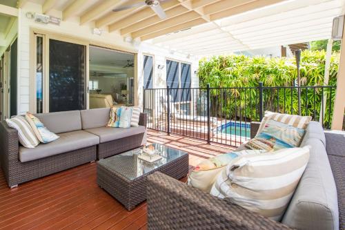a living room with a couch and a table at Eeast on Picnic in Picnic Bay