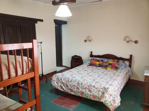 a bedroom with a bed and a crib in it at Hospedaje Casa Gaite in Maimará