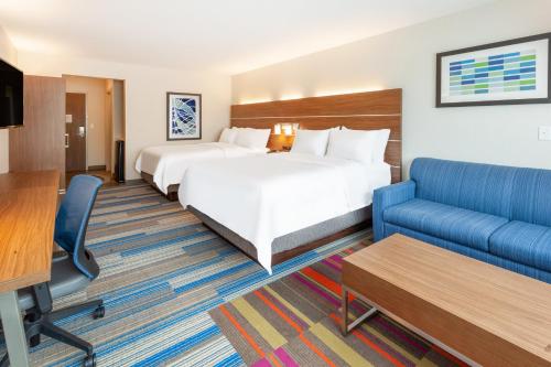 a hotel room with two beds and a couch at Holiday Inn Express & Suites Brunswick-Harpers Ferry Area by IHG in Brunswick