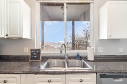 a kitchen counter with a sink and a window at Downtown Views-Prime Location! in Cincinnati