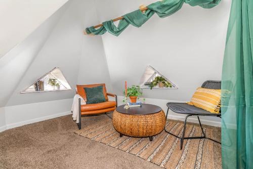 a living room with a table and chairs at Downtown Views-Prime Location! in Cincinnati