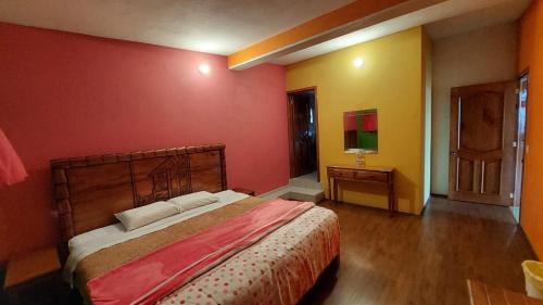 a bedroom with a large bed in a room at Posada El Volador in Cuetzalán del Progreso