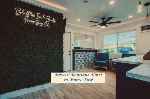 a kitchen and a living room with a wall at Blufftop Inn & Suites - Wharf/Restaurant District in Morro Bay