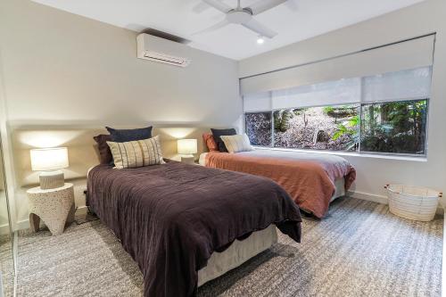 ein Schlafzimmer mit zwei Betten und einem Fenster in der Unterkunft Village vibes & coastal life, Sunshine Beach in Sunshine Beach