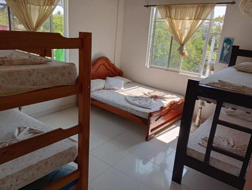 a room with two bunk beds and a window at Sol y Mar in Puerto Limón
