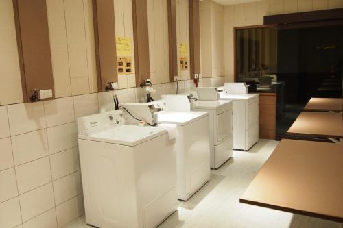 a row of white washing machines in a room at Fantasy Palace in Yuchi