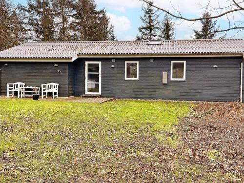a blue house with a table and chairs in front of it at 6 person holiday home in Vesløs-By Traum in Øsløs