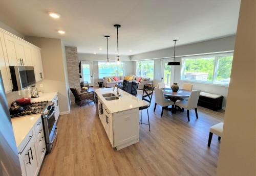 a kitchen and living room with a dining room and a living room at Boardman Ridge Penthouse Close to Town in Traverse City