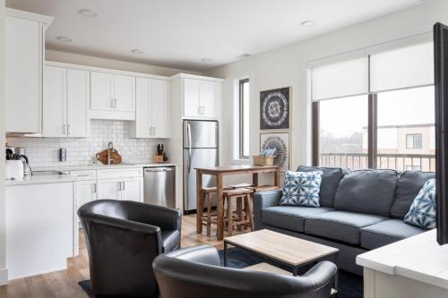 a kitchen and living room with a couch and a table at Capri 315 the Heart of Old Town Traverse City in Traverse City